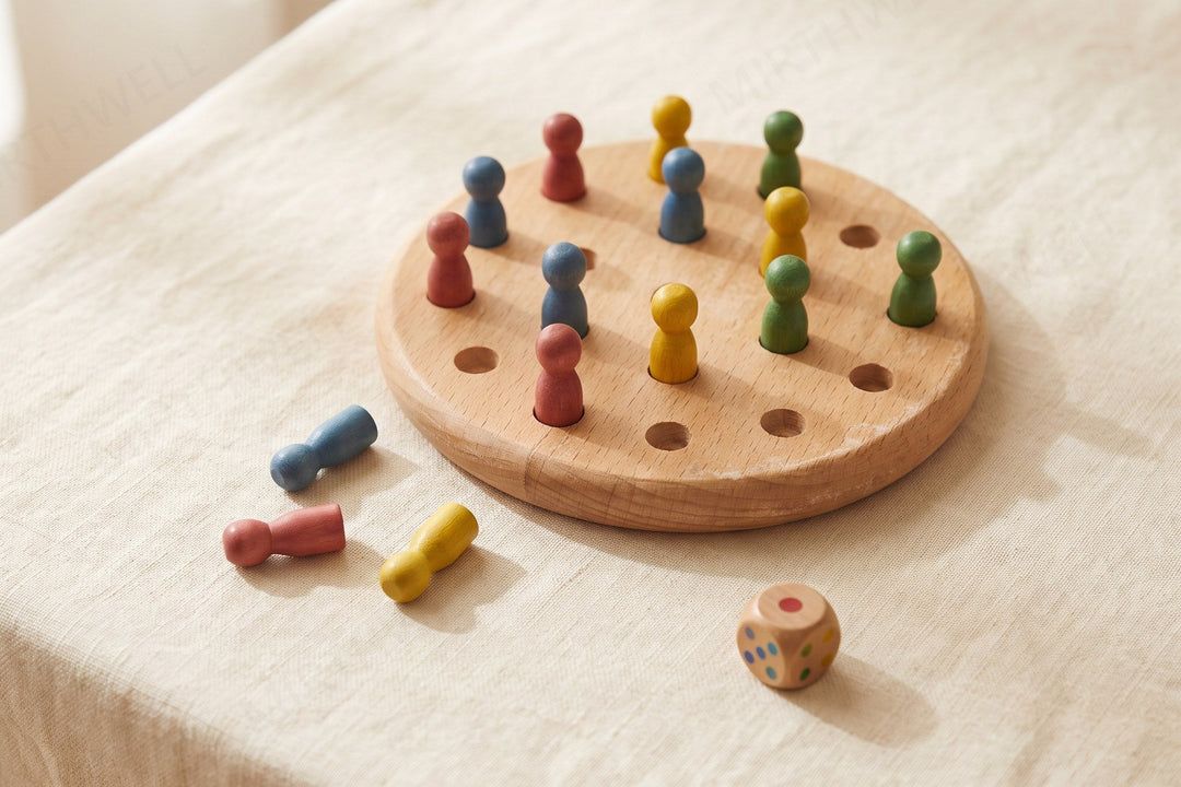 A round wooden peg board with small colored pegs, some standing in holes and some lying loose beside it, and a small wooden color die on a cream tablecloth.