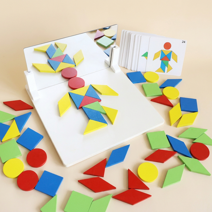 Montessori mirror puzzle, Geometric shapes version: white wooden base with a standing acrylic mirror on two white stands, coloured wooden shapes and pattern cards
