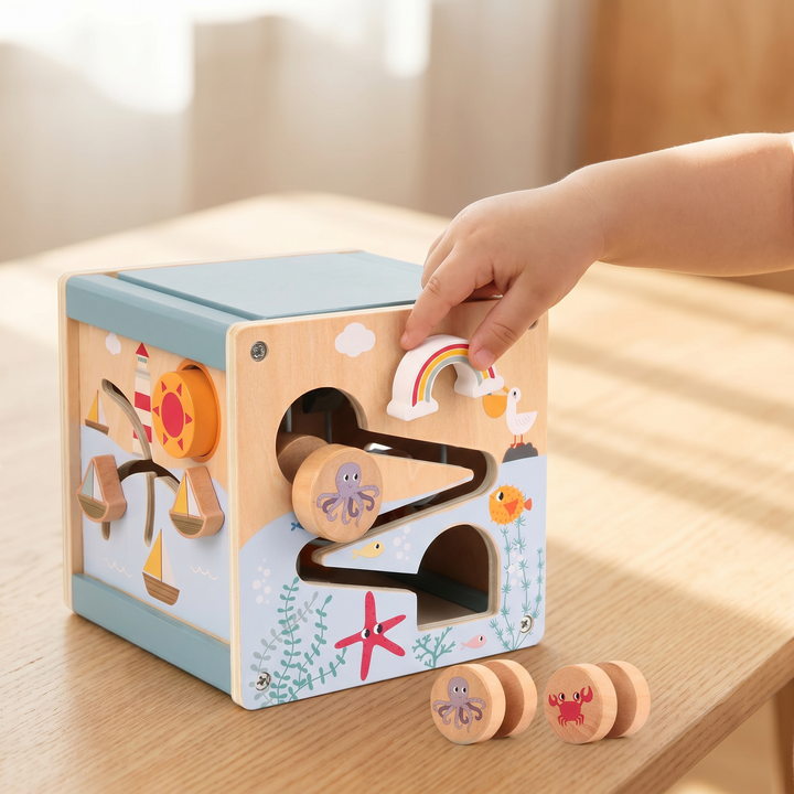Wooden 5-in-1 Activity Cube for Toddlers — a child playing with it