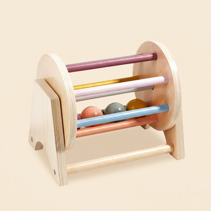 Wooden spinning drum sensory toy, clean product shot on warm cream.