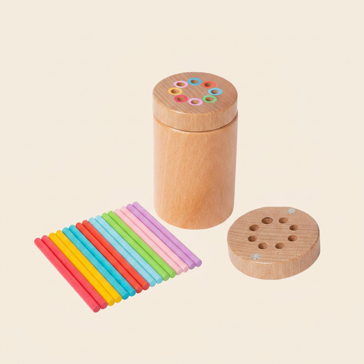 Wooden color-matching stick canister on warm cream - solid-wood pot with a color-ringed lid and rainbow wooden sticks