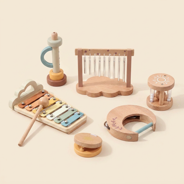7-piece wooden baby music set on warm cream - xylophone, wind chime, whistle, moon tambourine, sun rattle and star castanet