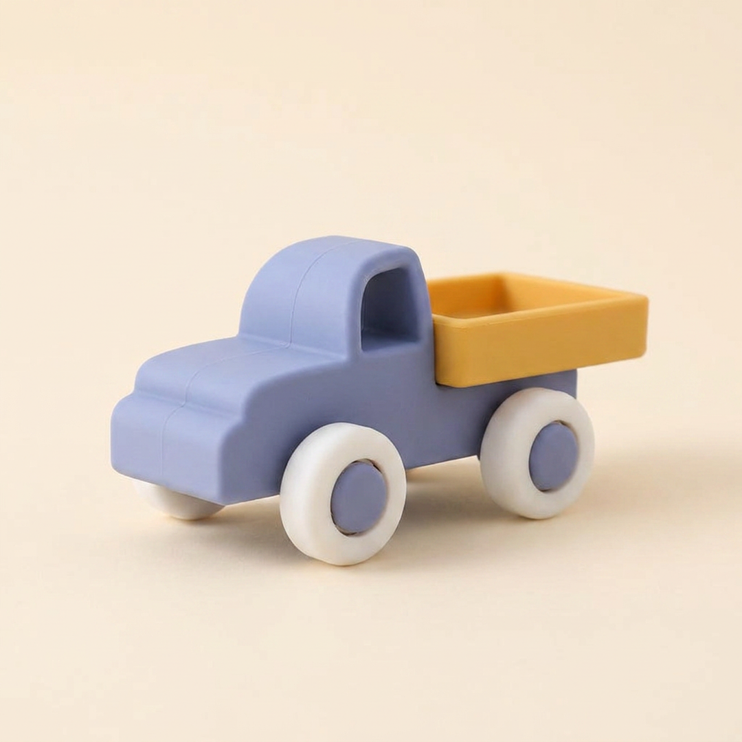 Soft silicone toy lorry on warm cream - powder-blue cab, mustard tray and soft rolling wheels