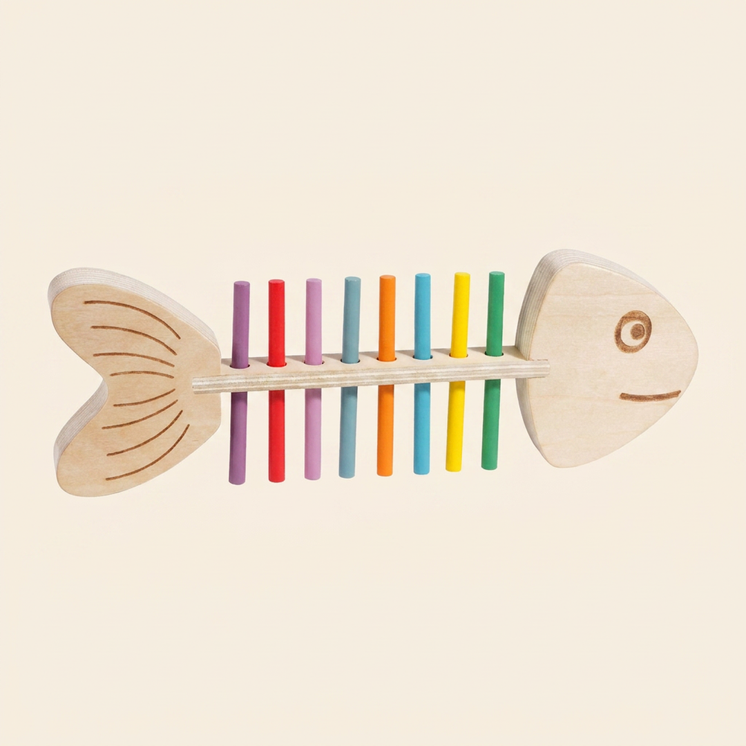Wooden fish color-matching peg toy on warm cream - engraved fish frame with a full row of rainbow sticks