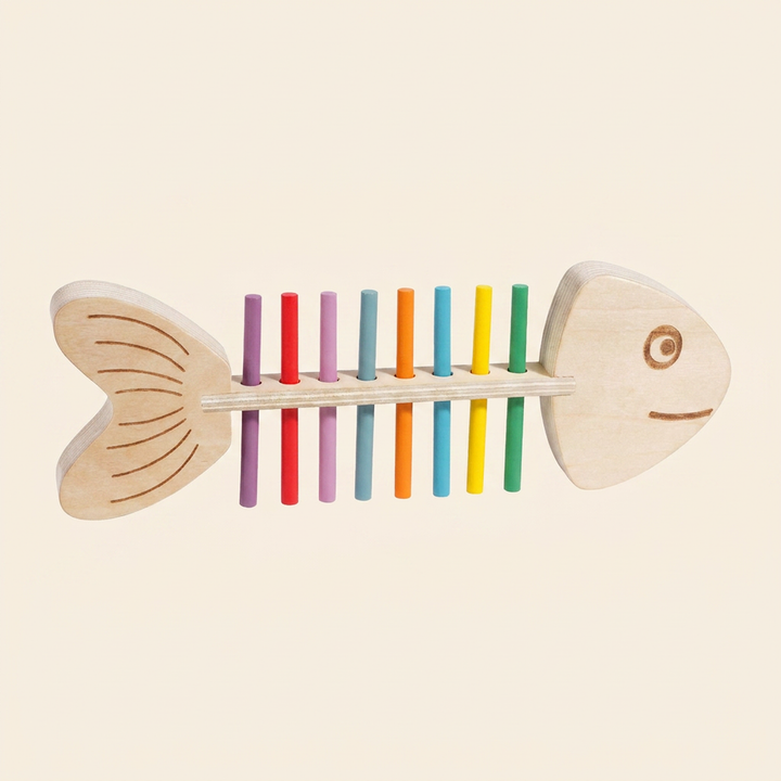Wooden fish color-matching peg toy on warm cream - engraved fish frame with a full row of rainbow sticks