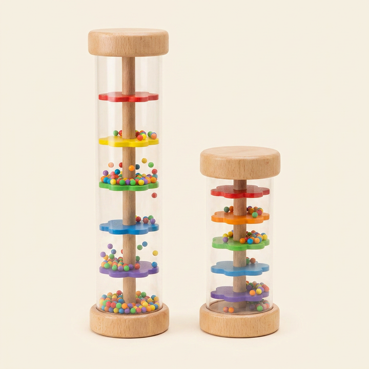 Wooden rainmaker rain stick in two sizes on warm cream - wood caps, clear body, rainbow baffles and colorful beads inside