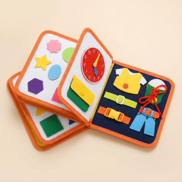 Felt quiet book fanned open to reveal the numbers, alphabet and dressing-skills pages