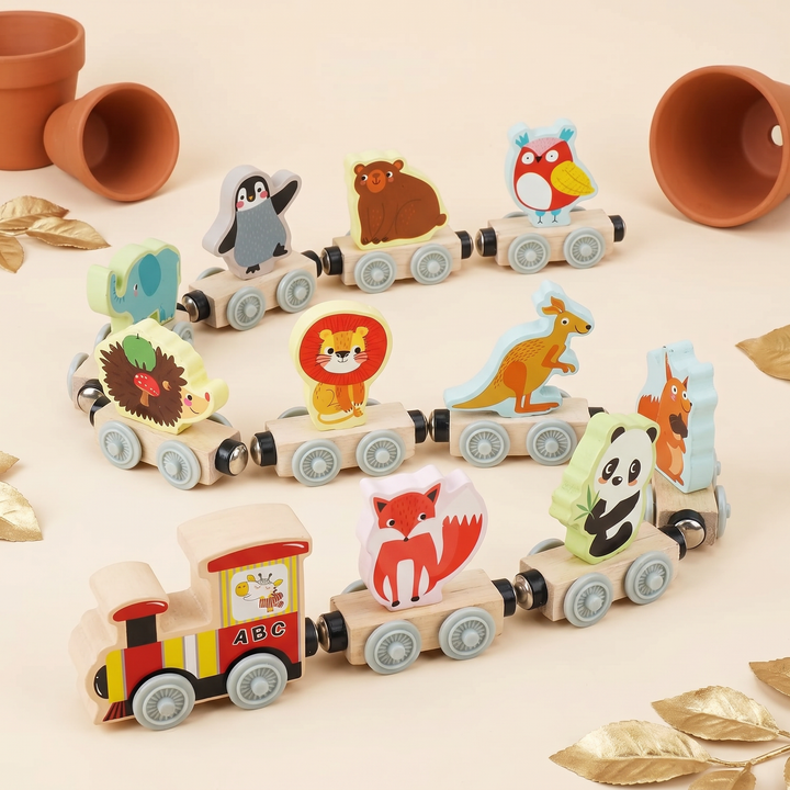 The full set - ten wooden animals lined up beside their carriages and the ABC engine