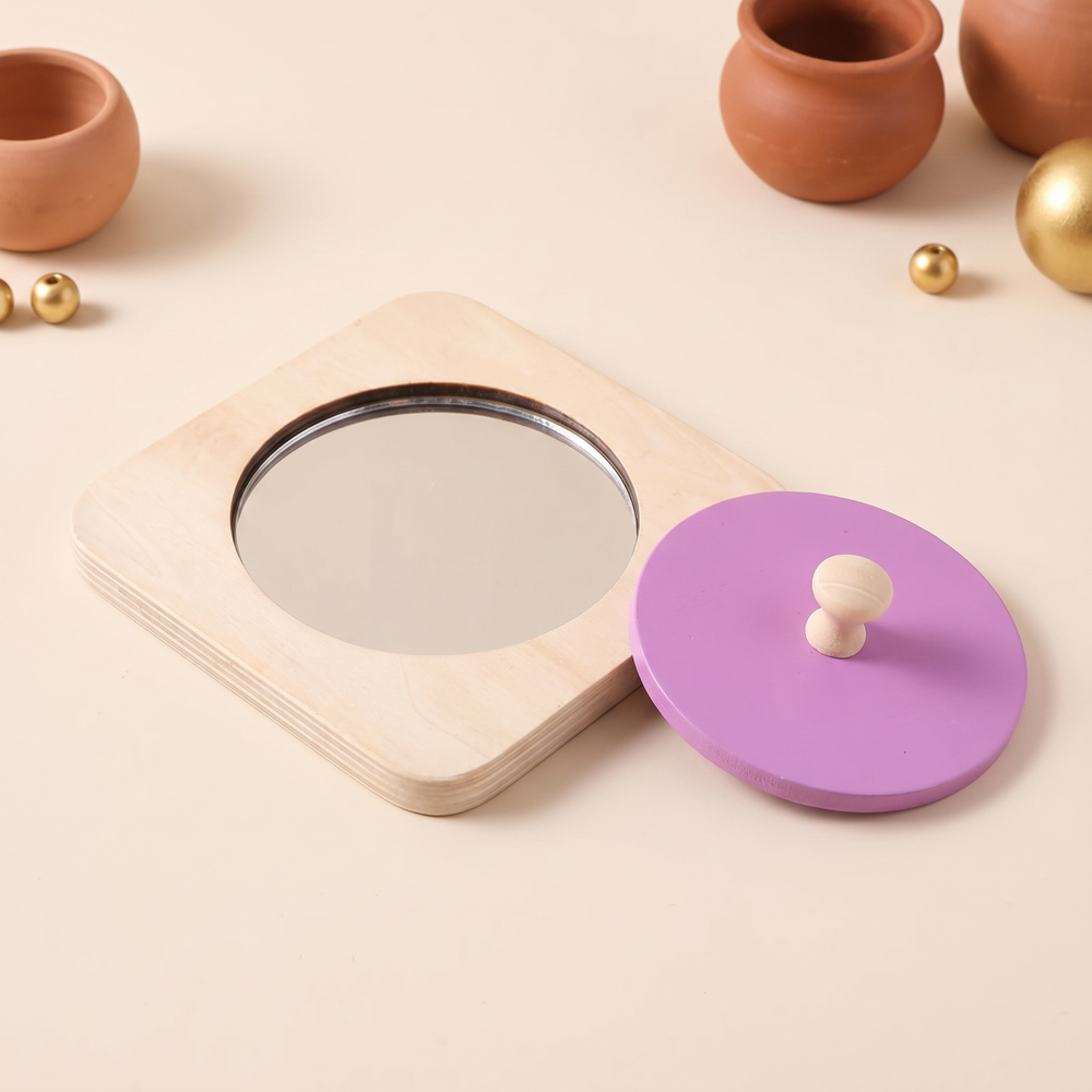 Three-quarter view of the birch mirror puzzle with the purple knob disc set to one side