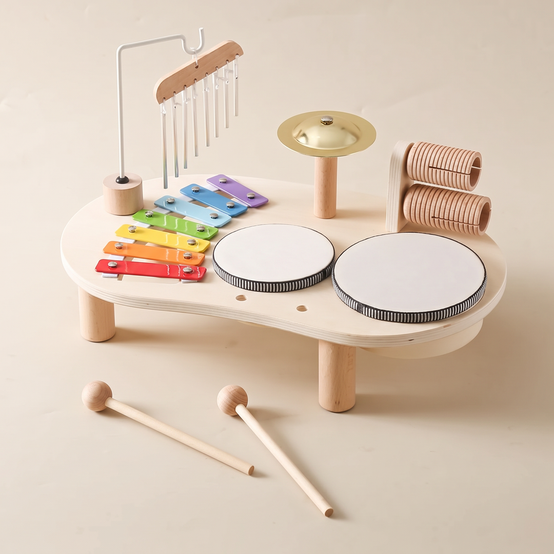 Wooden music table from a three-quarter angle showing all five instrument stations and the mallets