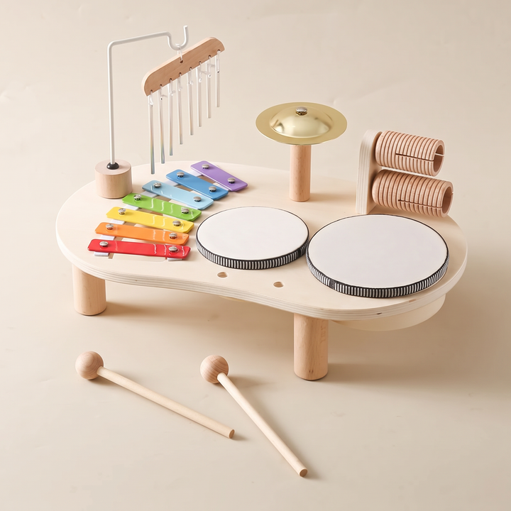 Wooden music table from a three-quarter angle showing all five instrument stations and the mallets