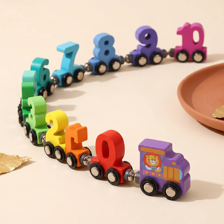The assembled wooden number train curving away, lion engine pulling the full 0 to 10 line of cars
