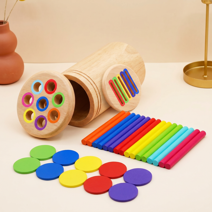 Two-sided lid lifted off - color-ringed round holes on one face, rainbow flat slots on the other, with sticks and discs