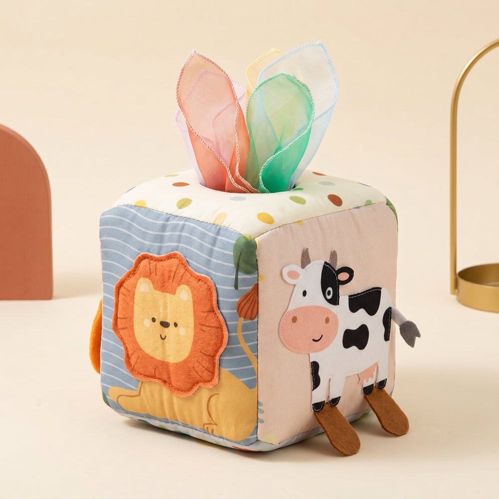 Fabric sensory cube turned to show the felt-legged cow and sewn-mane lion panels
