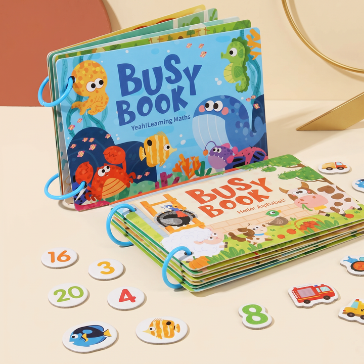 Two busy book themes fanned side by side on their binder rings with a spread of picture cards