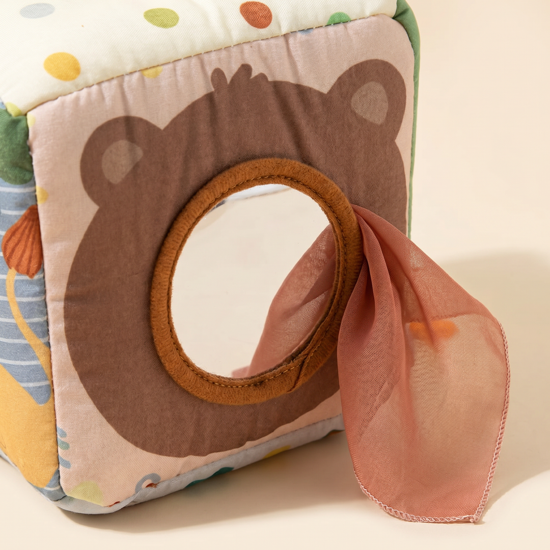 Close-up of the bear-face panel with its round baby-safe mirror