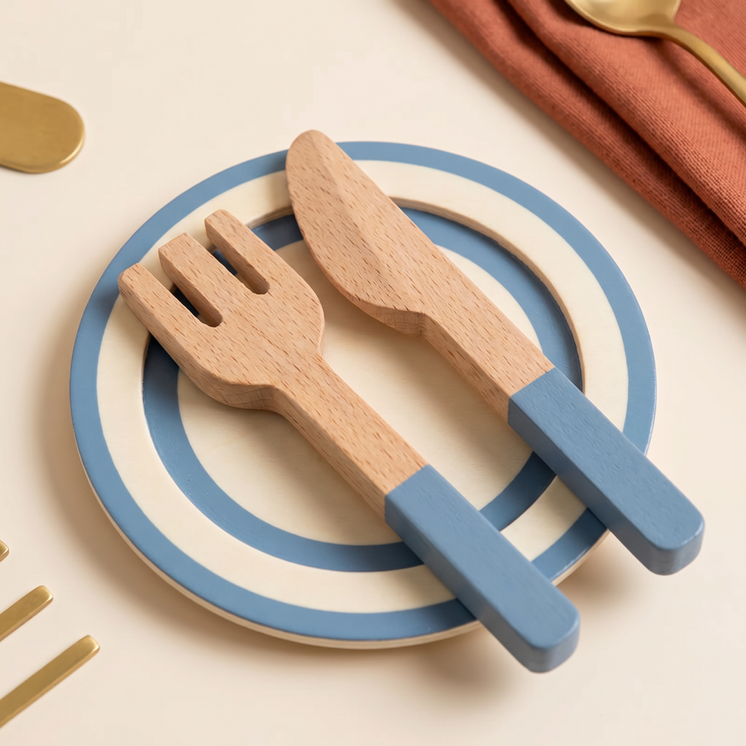 Close-up of the wooden fork and knife on a cream-and-blue plate