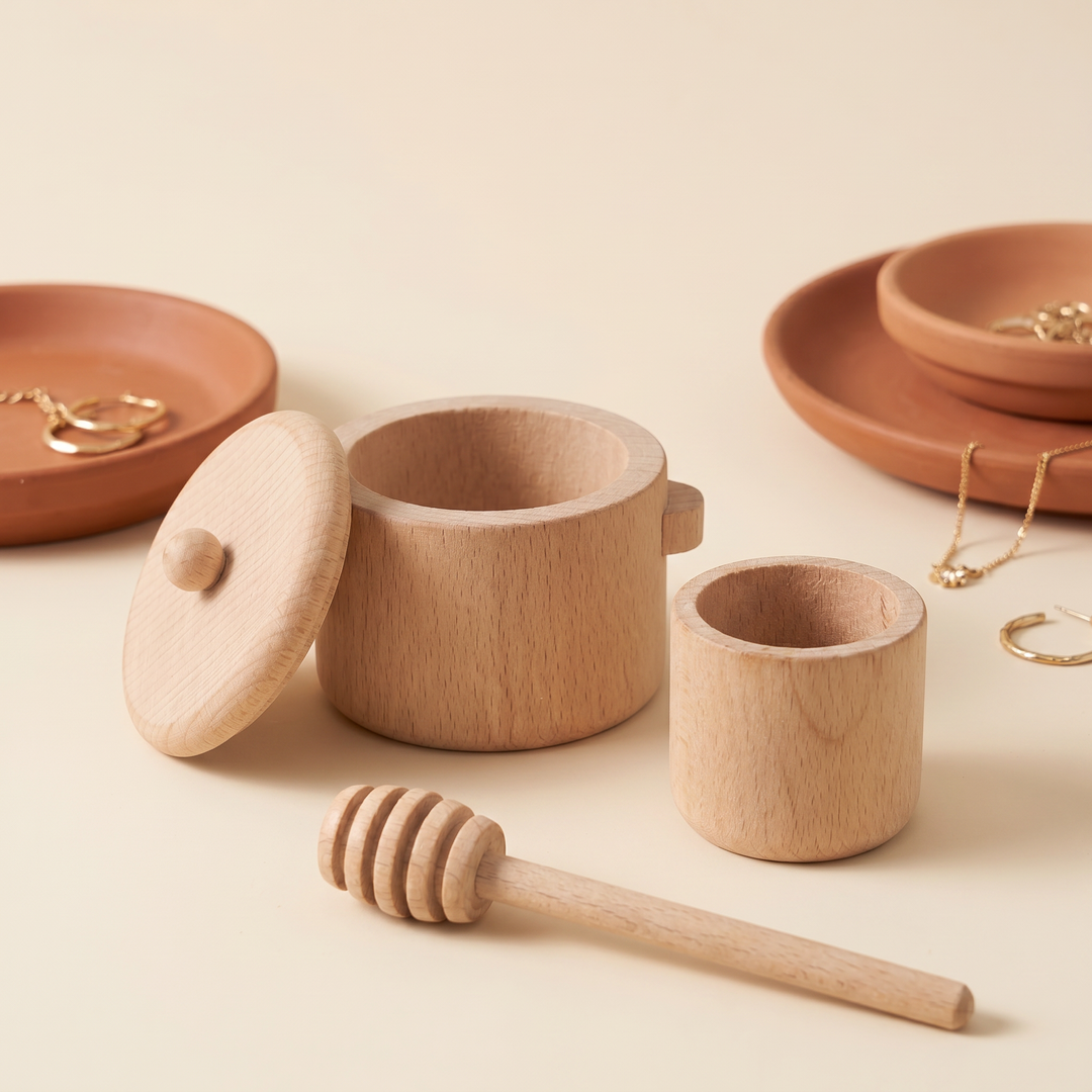 Close-up of the wooden lidded pot, small cup and honey-dipper stick showing the beech grain