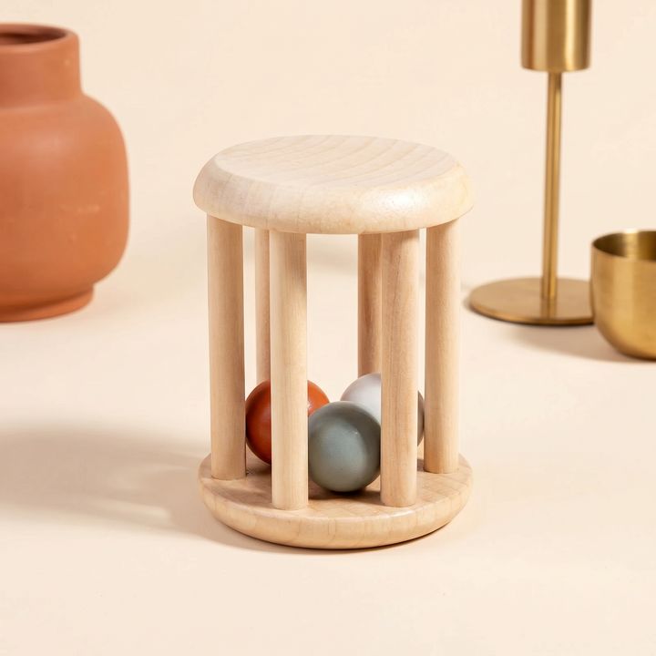 Close-up of the wooden roller-drum cage with loose colored wooden balls resting inside