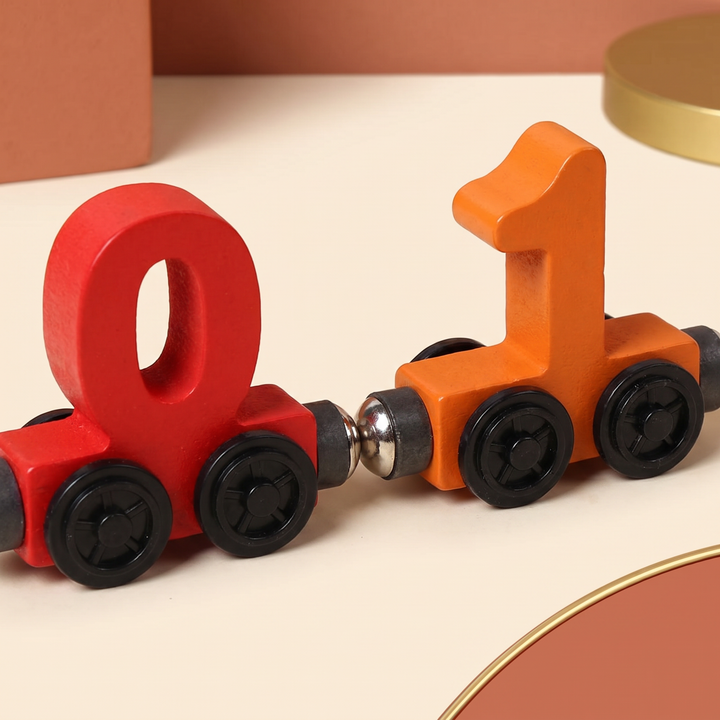 Close-up of two wooden number cars coupling together with their magnetic connector tips