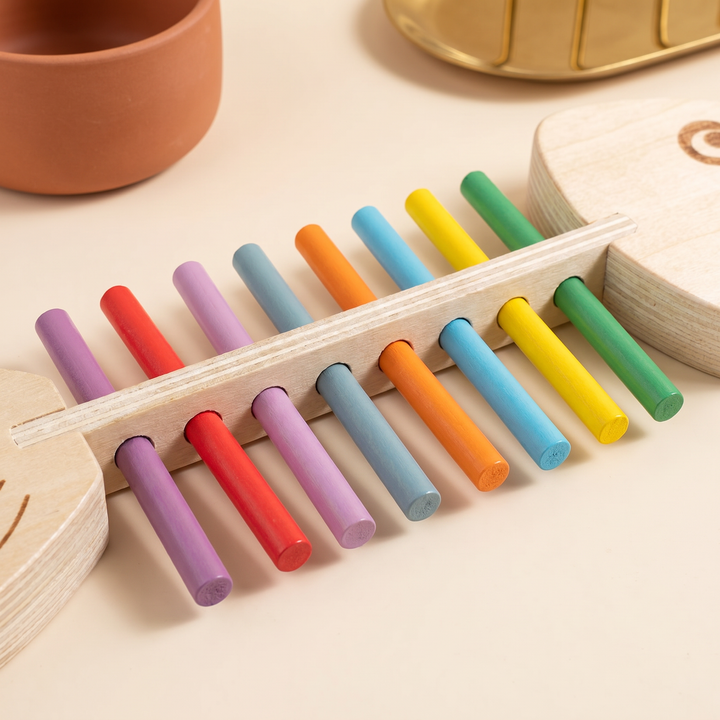 Close-up of the rainbow colored wooden sticks pressed into the slotted wooden spine