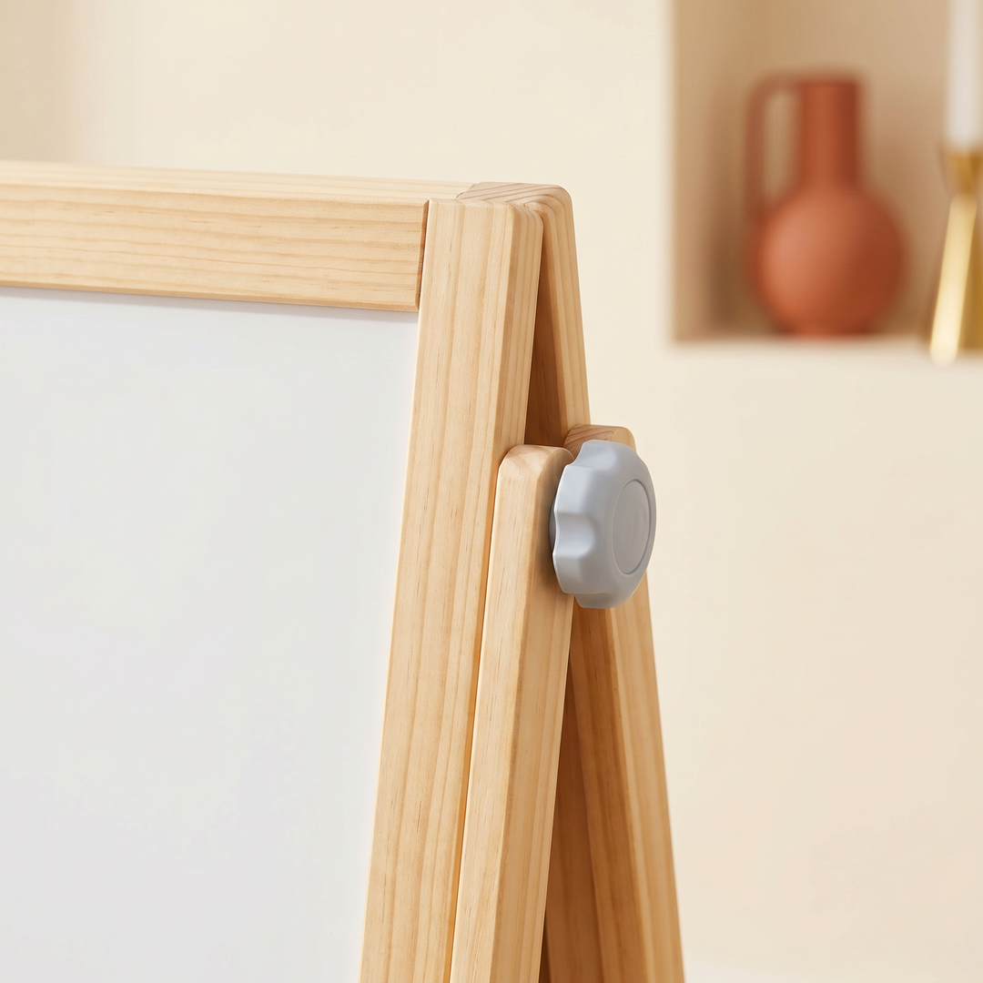 Close-up of the natural-pine frame and grey pivot knob where the board rotates