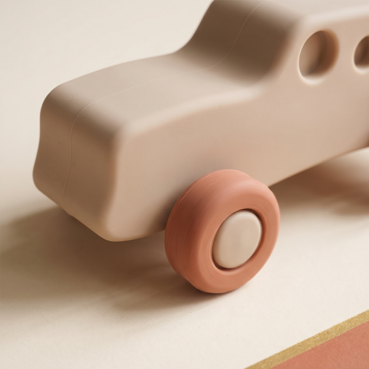 Close-up of a soft silicone toy car showing its smooth matte surface and soft wheel