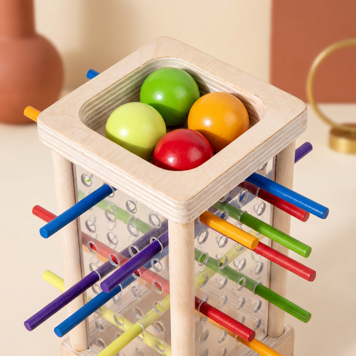 Close-up of the colored wooden balls resting in the top of the clear tower