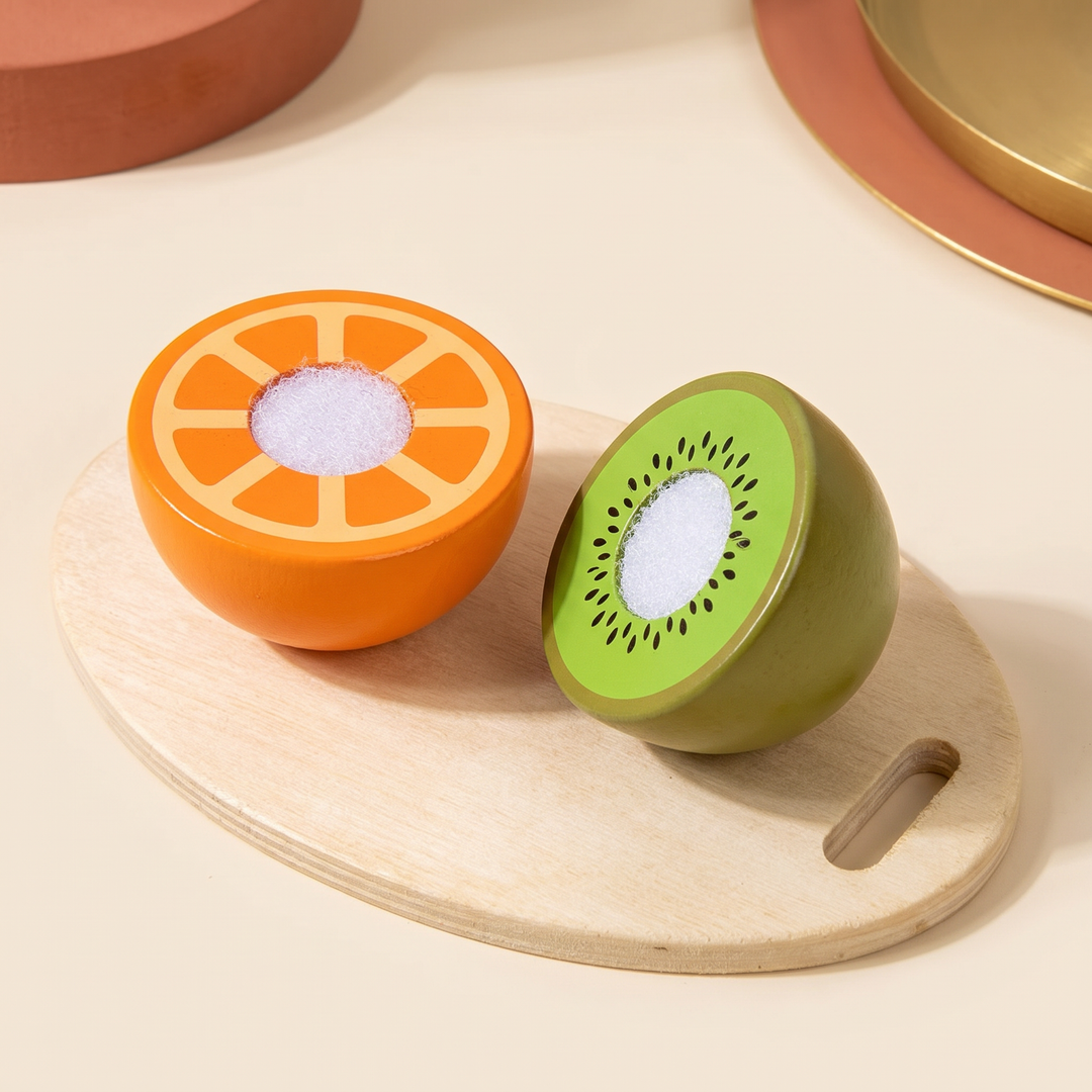 Close-up of two wooden food halves pulled apart to show the printed orange and kiwi interiors