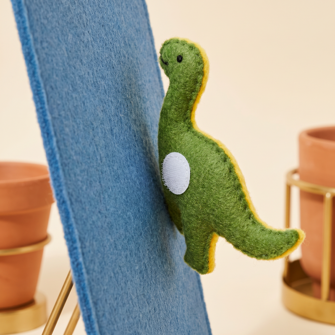 Close-up of a soft felt figure piece with its hook-and-loop tab pressed against the felt board