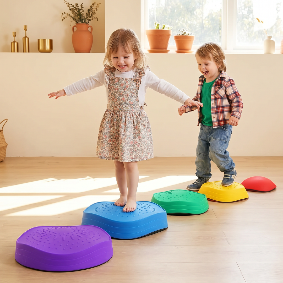 Two children crossing a path of stepping stones in a playroom