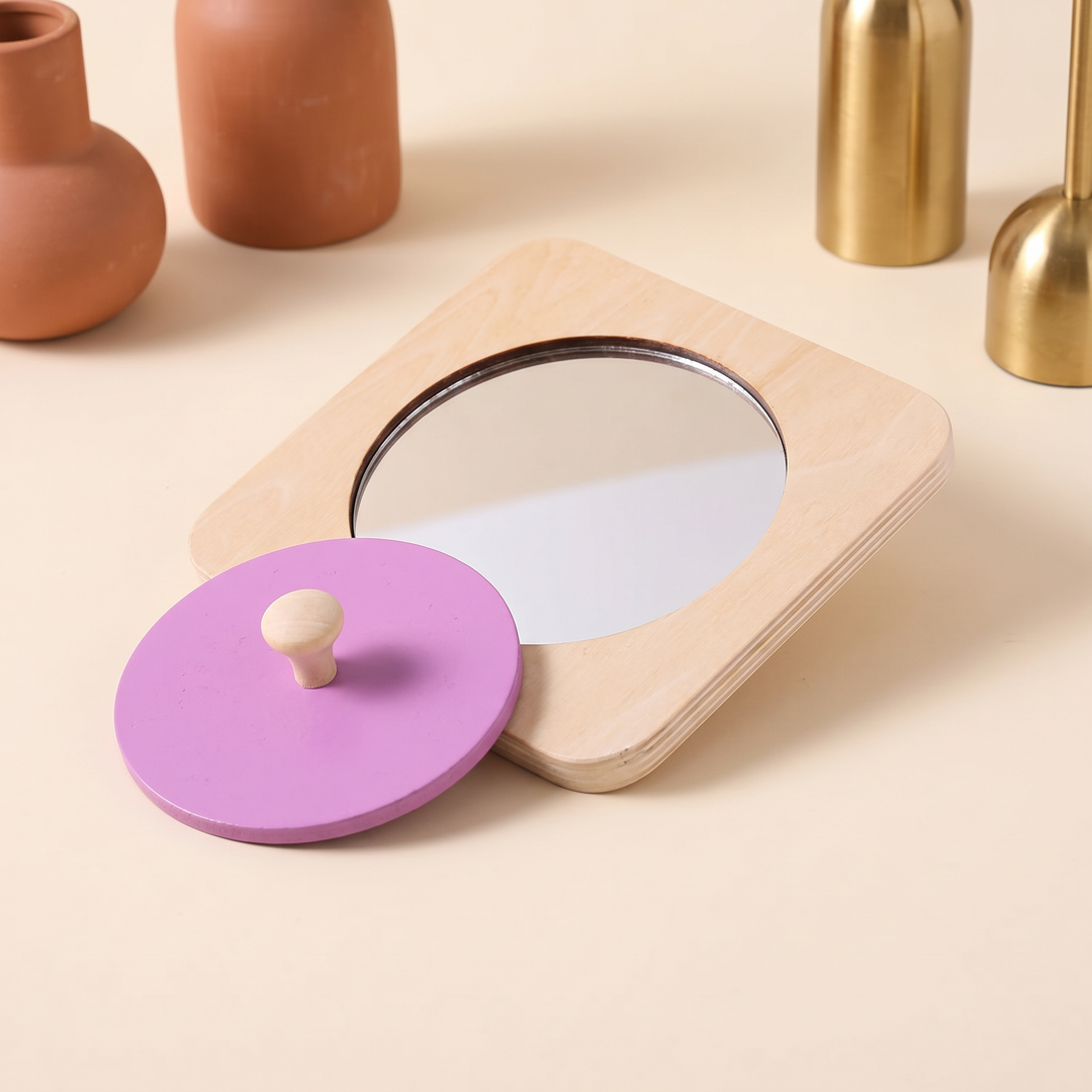 The birch mirror puzzle board with its purple knob disc lifted off beside it
