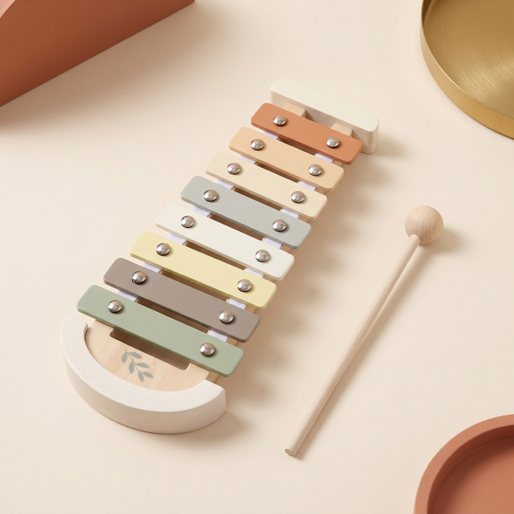 Beechwood xylophone with eight pastel tone bars and the wooden mallet resting beside it