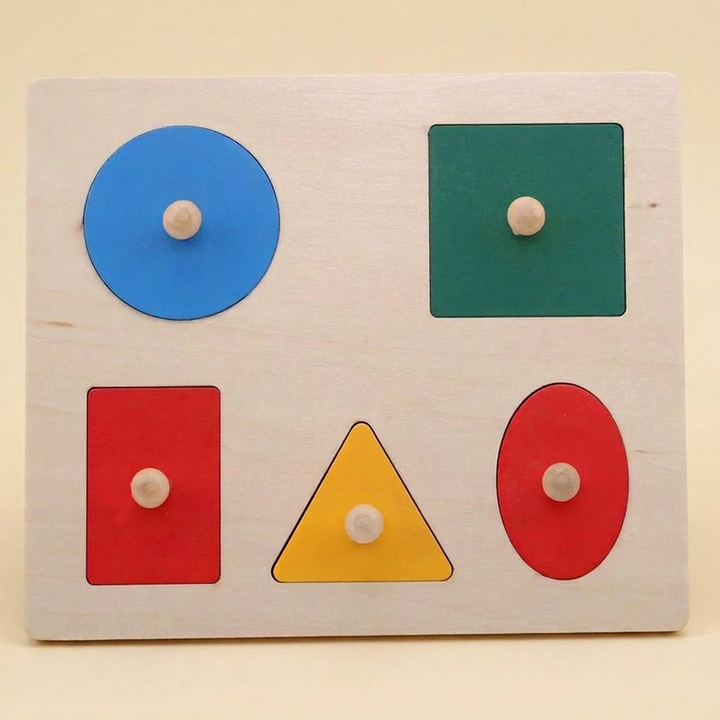 Wooden shape puzzle: rectangular board with five mixed shapes (circle, square, rectangle, triangle, oval)